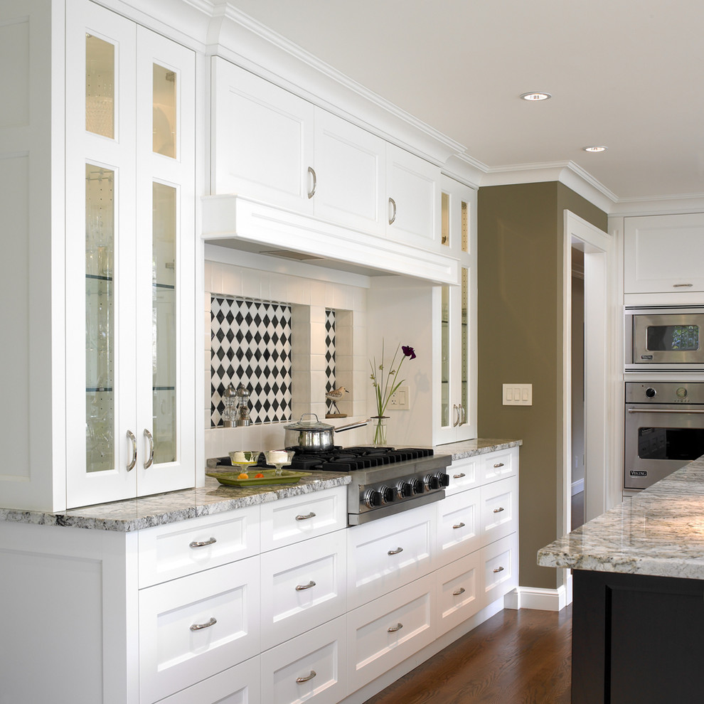 Design ideas for a transitional kitchen in Vancouver with glass-front cabinets and stainless steel appliances.