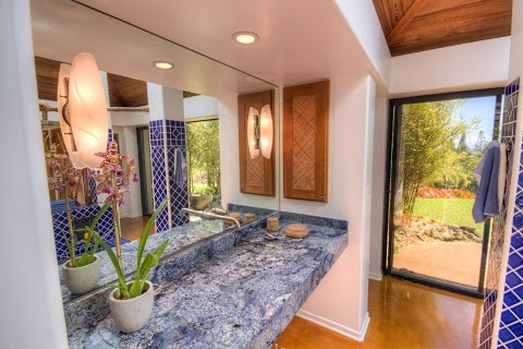 Large eclectic master bathroom in Other with a hot tub, blue tile, porcelain tile, white walls, concrete floors, granite benchtops and brown floor.