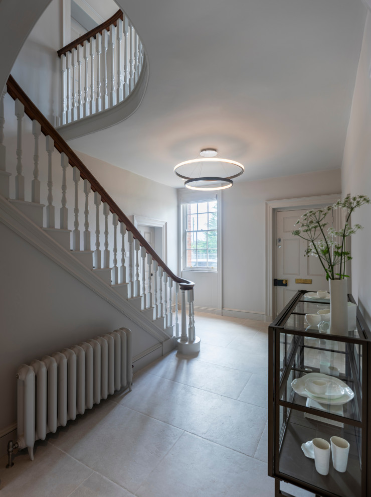 Photo of a large contemporary hallway in Oxfordshire with white walls, ceramic floors and white floor.