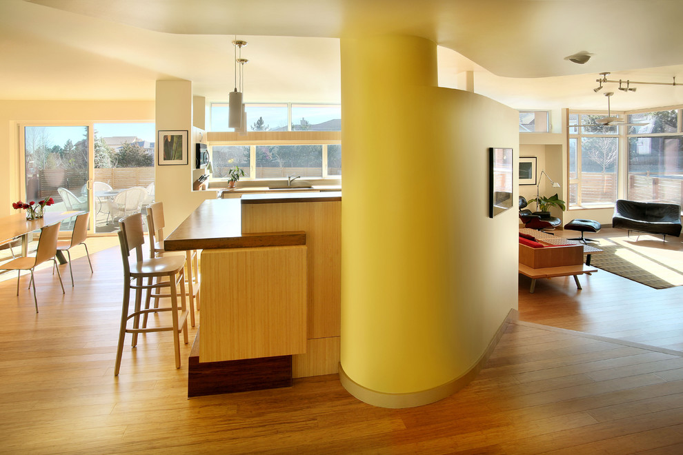 Design ideas for a contemporary open plan kitchen in Denver with flat-panel cabinets and light wood cabinets.