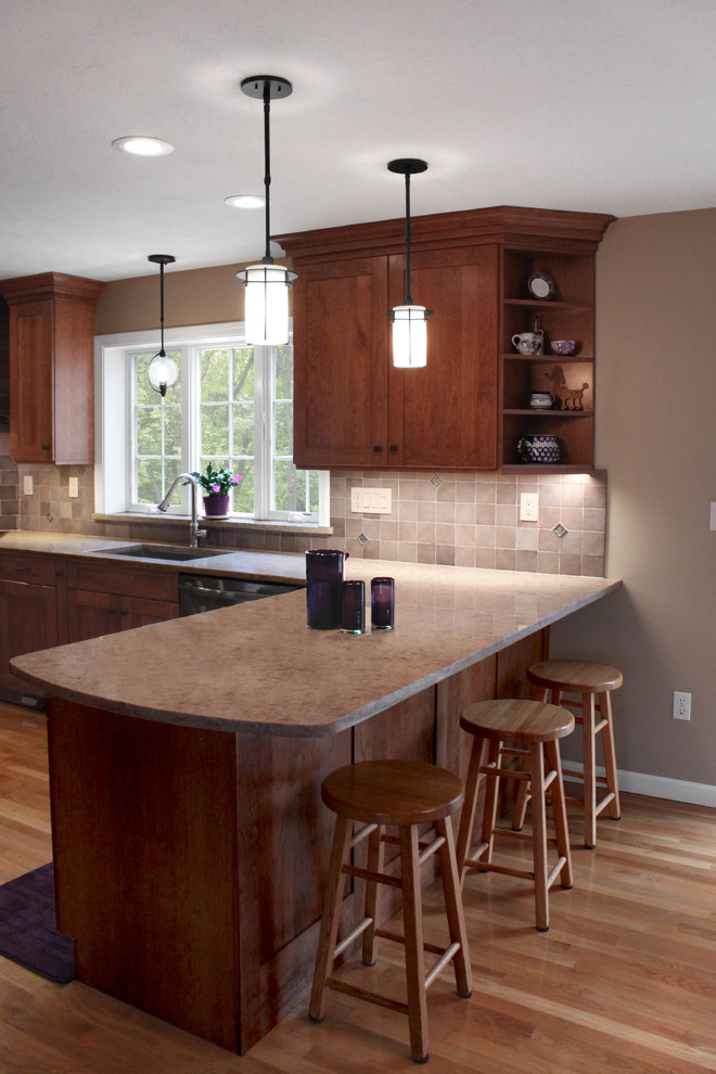 Large transitional u-shaped light wood floor eat-in kitchen photo in Boston with an undermount sink, shaker cabinets, medium tone wood cabinets, quartz countertops, gray backsplash, porcelain backsplash, stainless steel appliances and a peninsula