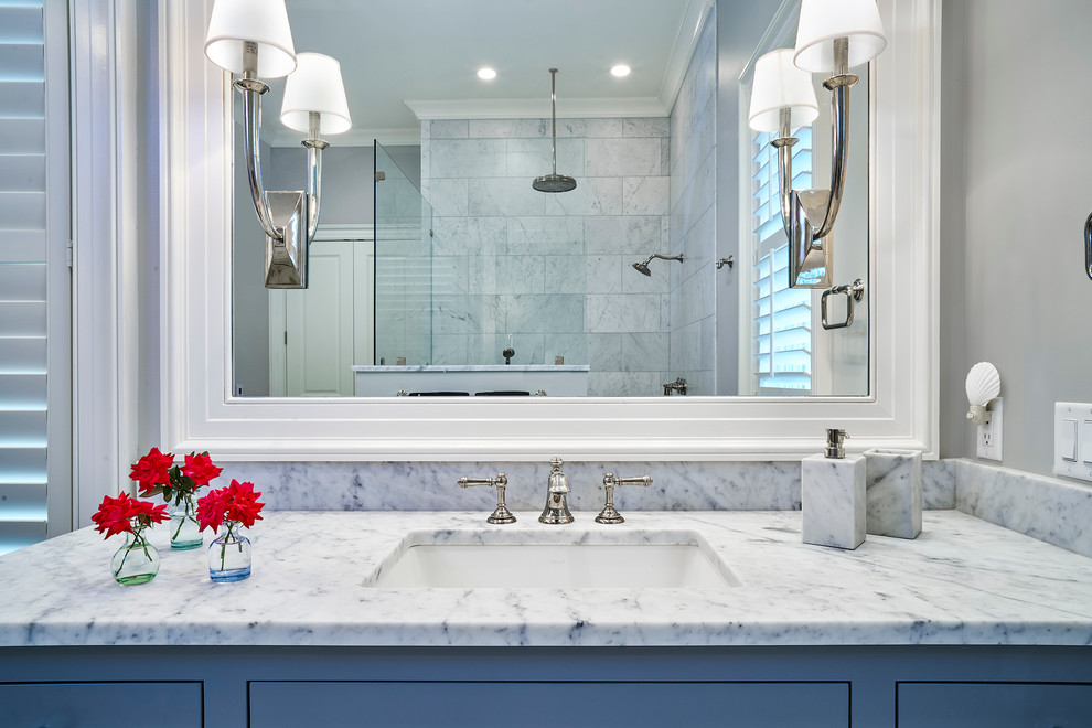 Design ideas for a mid-sized transitional master bathroom in Charleston with flat-panel cabinets, grey cabinets, a curbless shower, a one-piece toilet, gray tile, subway tile, grey walls, marble floors, an undermount sink and marble benchtops.