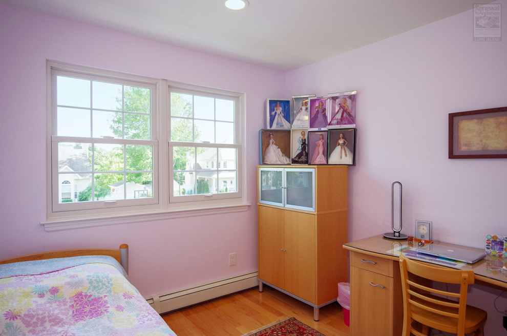 Design ideas for a mid-sized bedroom in New York with pink walls, medium hardwood floors, no fireplace and multi-coloured floor.