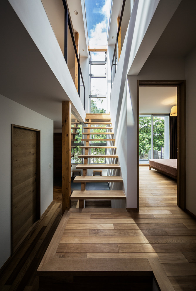 Inspiration for a contemporary wood straight staircase in Kobe with open risers.