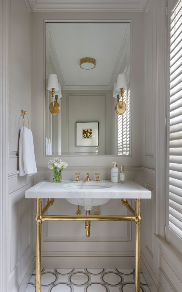 Powder room - traditional multicolored floor and wall paneling powder room idea in Boston with gray walls, an undermount sink and white countertops