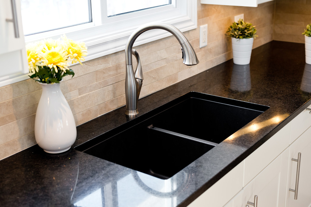 Kitchen - kitchen idea in Ottawa with an undermount sink, white cabinets, beige backsplash, mosaic tile backsplash, stainless steel appliances and an island