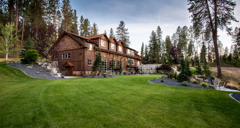 Inspiration for a huge rustic hillside concrete paver retaining wall landscape.