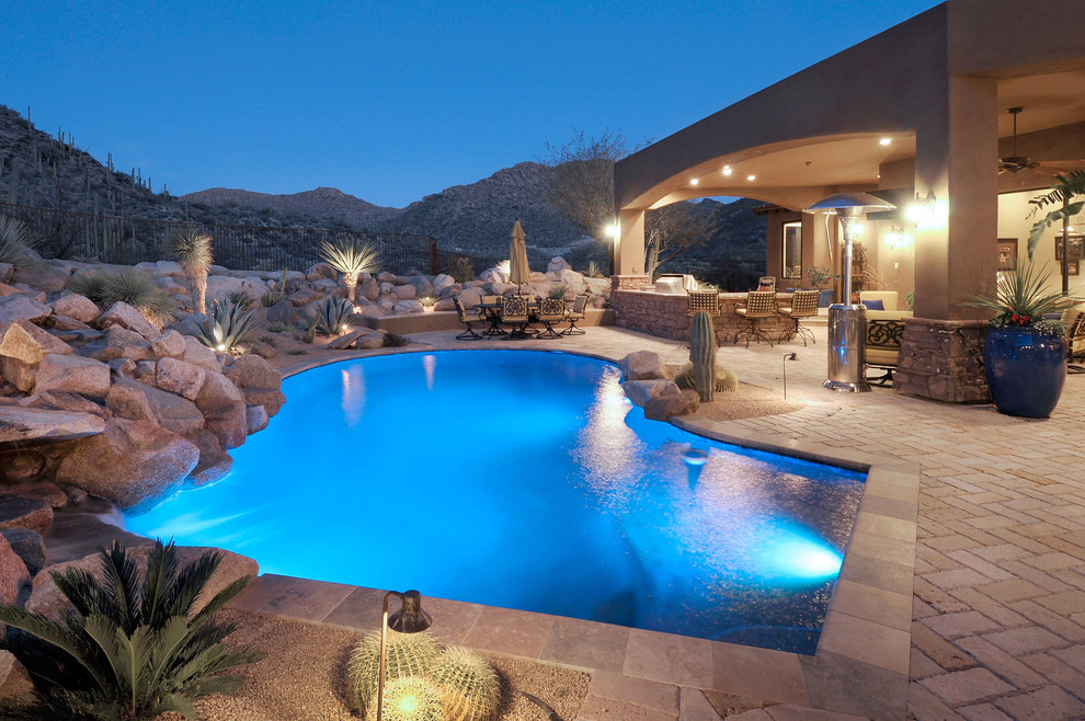 Custom-shaped pool in Phoenix with brick pavers.