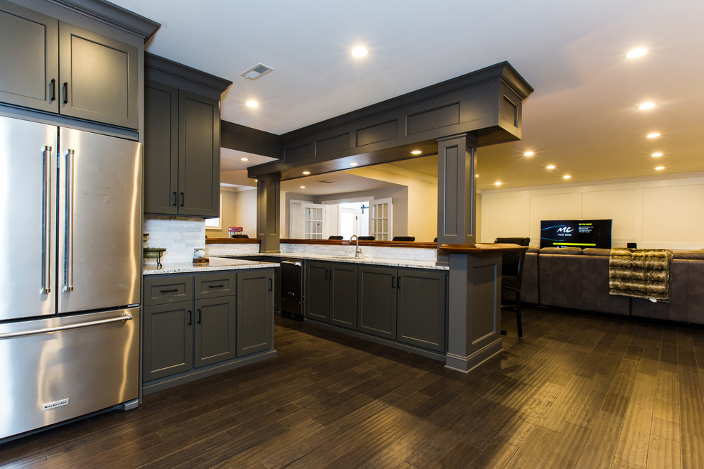 This is an example of a large contemporary u-shaped kitchen in Philadelphia with an undermount sink, recessed-panel cabinets, black cabinets, wood benchtops, white splashback, stone tile splashback, dark hardwood floors, brown floor and brown benchtop.