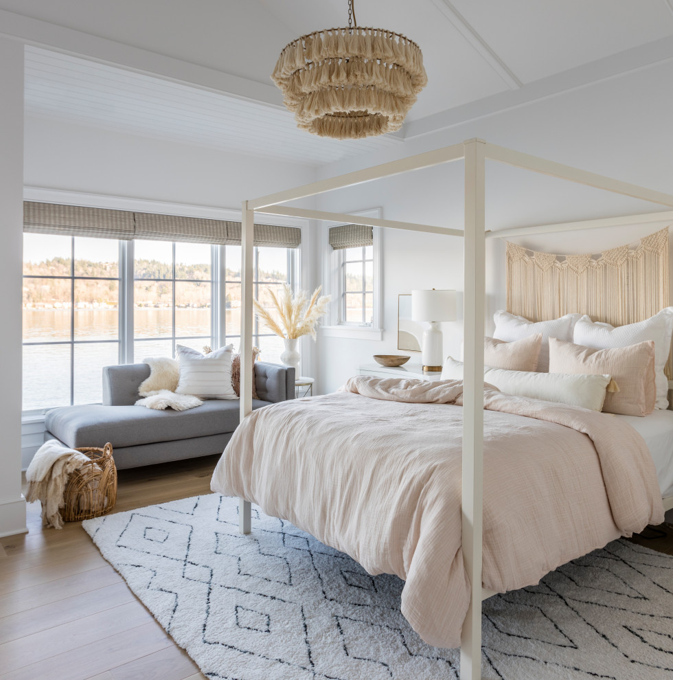 Beach style bedroom in Seattle with white walls, light hardwood floors, beige floor and vaulted.