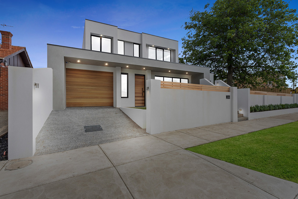 Design ideas for a mid-sized contemporary two-storey brick grey townhouse exterior in Melbourne with a flat roof and a metal roof.