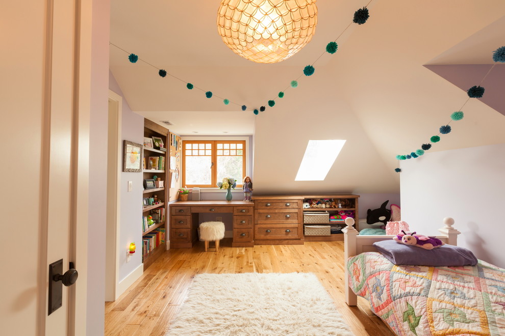 Design ideas for a mid-sized traditional kids' bedroom for kids 4-10 years old and girls in Seattle with purple walls and light hardwood floors.
