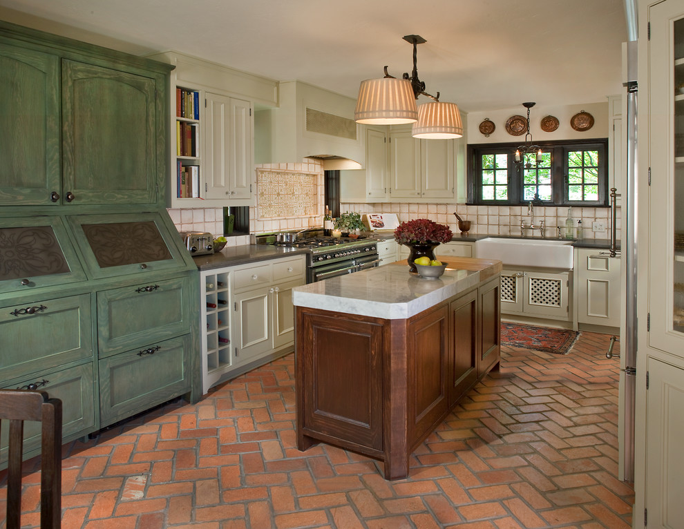 Photo of a traditional u-shaped separate kitchen in Dallas with beige cabinets, brick floors and with island.