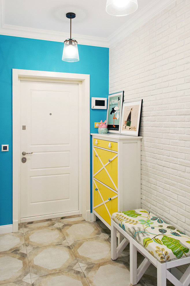 Eclectic entryway in Moscow with blue walls and a white front door.