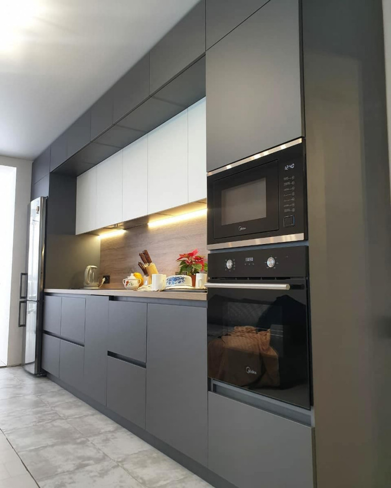 Photo of a large contemporary single-wall separate kitchen in Moscow with an undermount sink, flat-panel cabinets, grey cabinets, wood benchtops, brown splashback, timber splashback, black appliances, ceramic floors, no island, grey floor and brown benchtop.