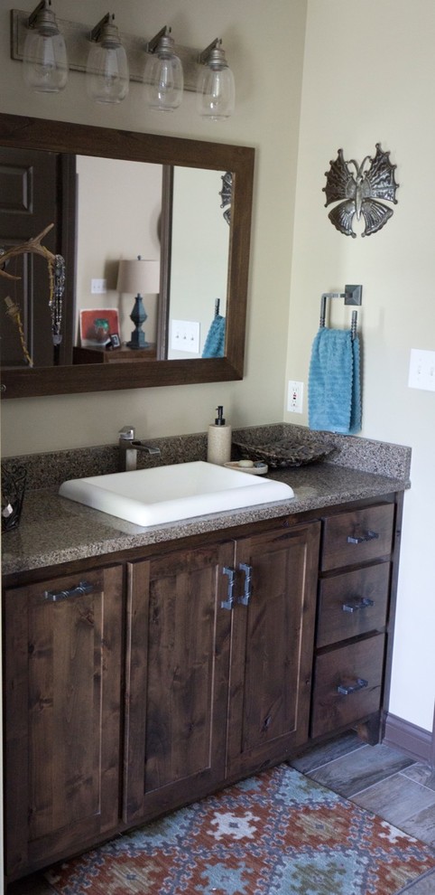This is an example of a mid-sized country master bathroom in Nashville with shaker cabinets, dark wood cabinets, laminate benchtops, an open shower, a one-piece toilet, beige tile, brown tile, porcelain tile, beige walls, porcelain floors and a drop-in sink.