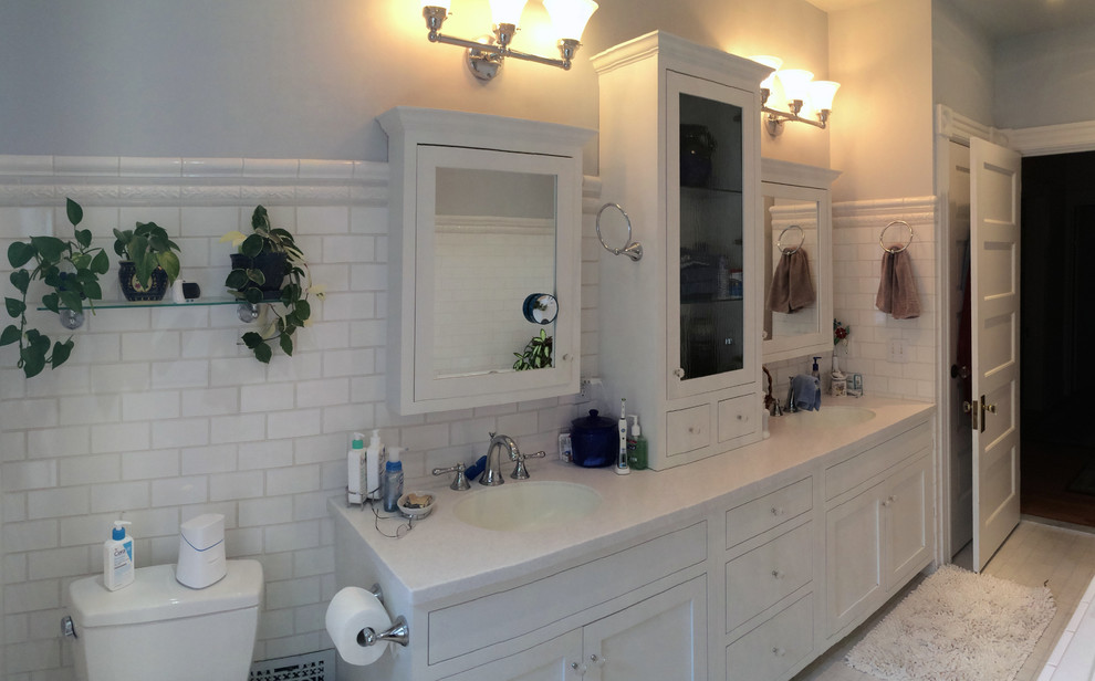 Large traditional master bathroom in Philadelphia with an integrated sink, shaker cabinets, white cabinets, limestone benchtops, a drop-in tub, an alcove shower, a two-piece toilet, white tile, subway tile, blue walls and ceramic floors.