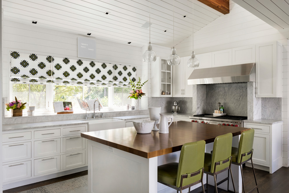 Inspiration for a transitional kitchen in New York with a farmhouse sink, shaker cabinets, white cabinets, stainless steel appliances, dark hardwood floors and with island.