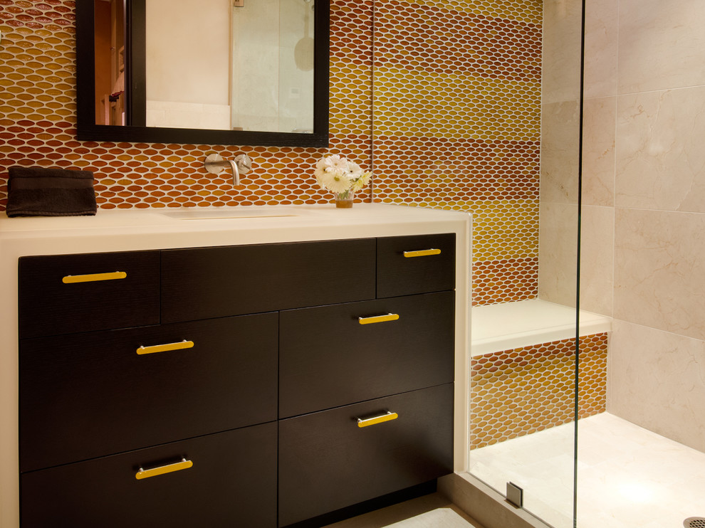 Photo of a mid-sized contemporary 3/4 bathroom in Denver with an undermount sink, flat-panel cabinets, dark wood cabinets, an alcove shower, yellow walls, marble floors, solid surface benchtops and multi-coloured tile.