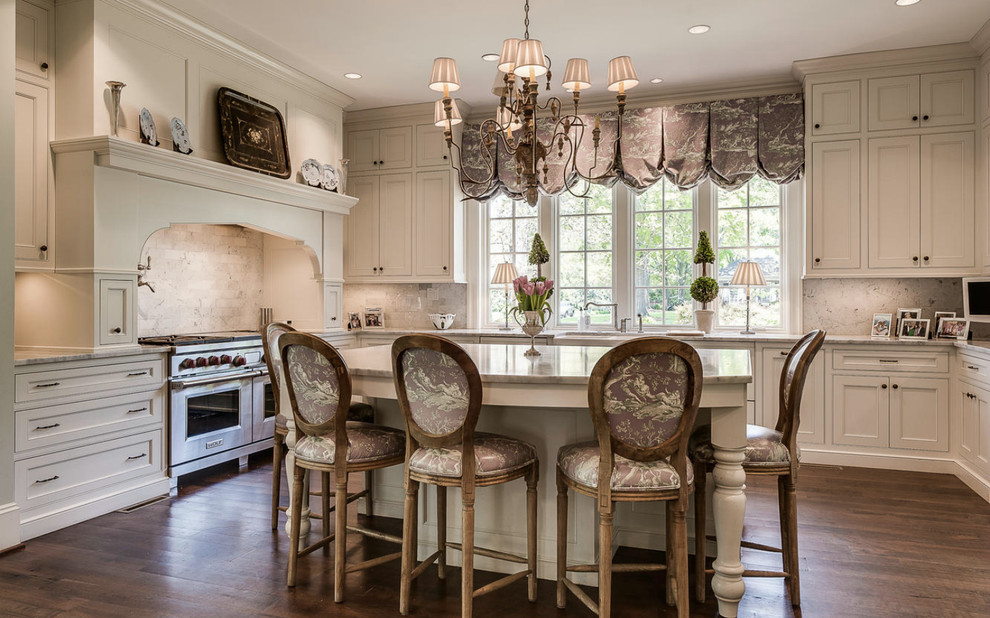 Inspiration for a timeless u-shaped dark wood floor kitchen remodel in Charlotte with recessed-panel cabinets, white cabinets, white backsplash, stainless steel appliances and an island