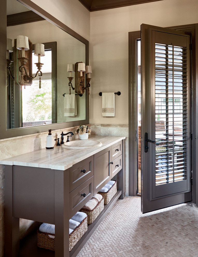 Design ideas for a traditional bathroom in Charlotte with a drop-in sink, recessed-panel cabinets, dark wood cabinets, beige tile, beige walls and mosaic tile floors.