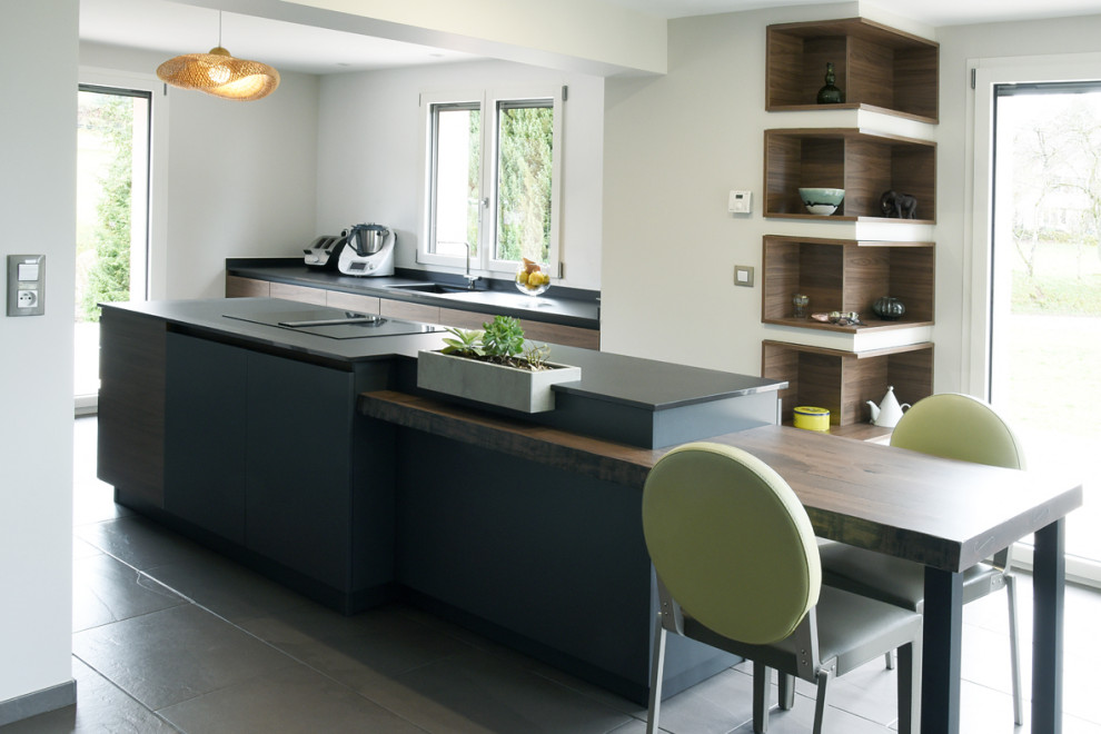 Inspiration for an expansive contemporary galley open plan kitchen in Nancy with a single-bowl sink, open cabinets, grey cabinets, panelled appliances, ceramic floors, with island and grey floor.