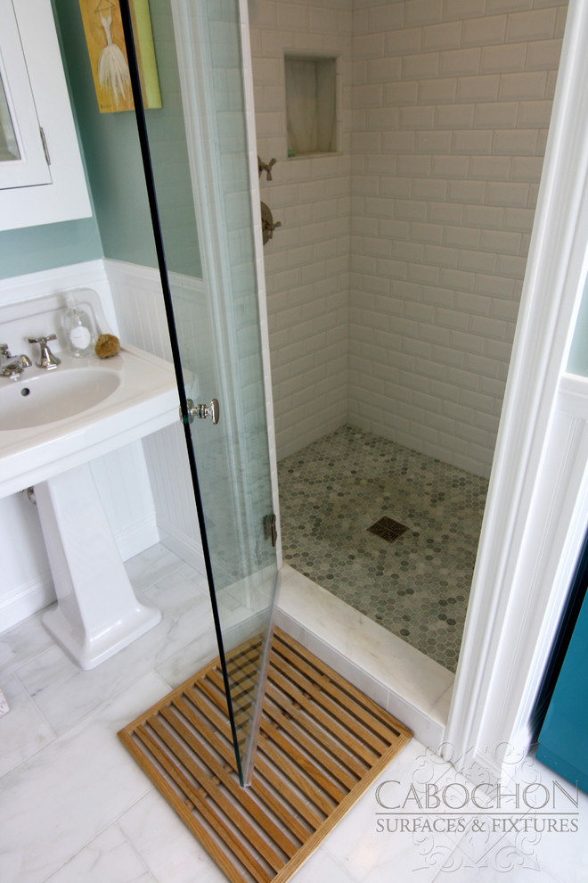 This is an example of a medium sized beach style ensuite bathroom in San Diego with a claw-foot bath, a corner shower, a two-piece toilet, freestanding cabinets, turquoise cabinets, white tiles, stone tiles, green walls and marble flooring.