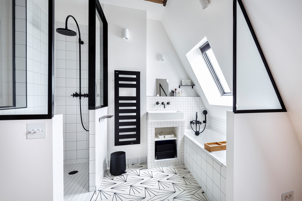 This is an example of a small modern master bathroom in Paris with an undermount tub, an open shower, white tile, ceramic tile, white walls, cement tiles, a drop-in sink, white floor and an open shower.