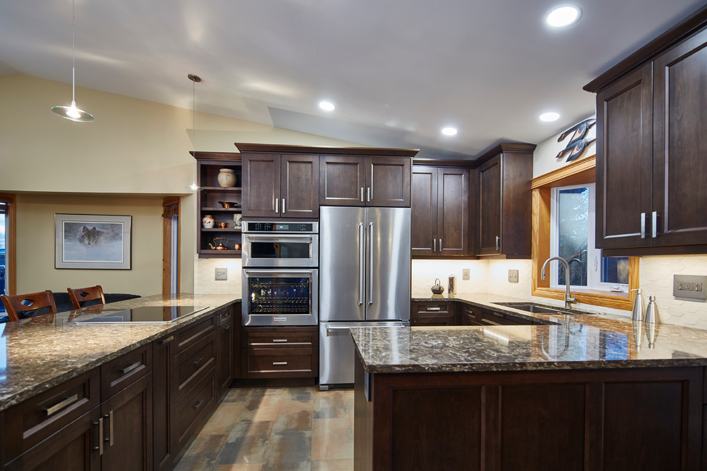 Eat-in kitchen - mid-sized transitional u-shaped porcelain tile eat-in kitchen idea with an undermount sink, shaker cabinets, dark wood cabinets, quartz countertops, beige backsplash, stone tile backsplash and stainless steel appliances