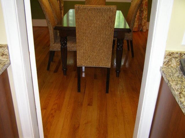 Example of a small medium tone wood floor dining room design with beige walls