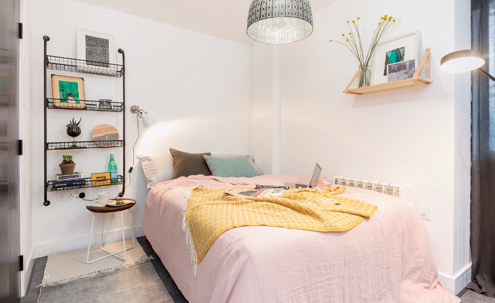 Design ideas for a scandinavian bedroom in Dorset with white walls and dark hardwood floors.