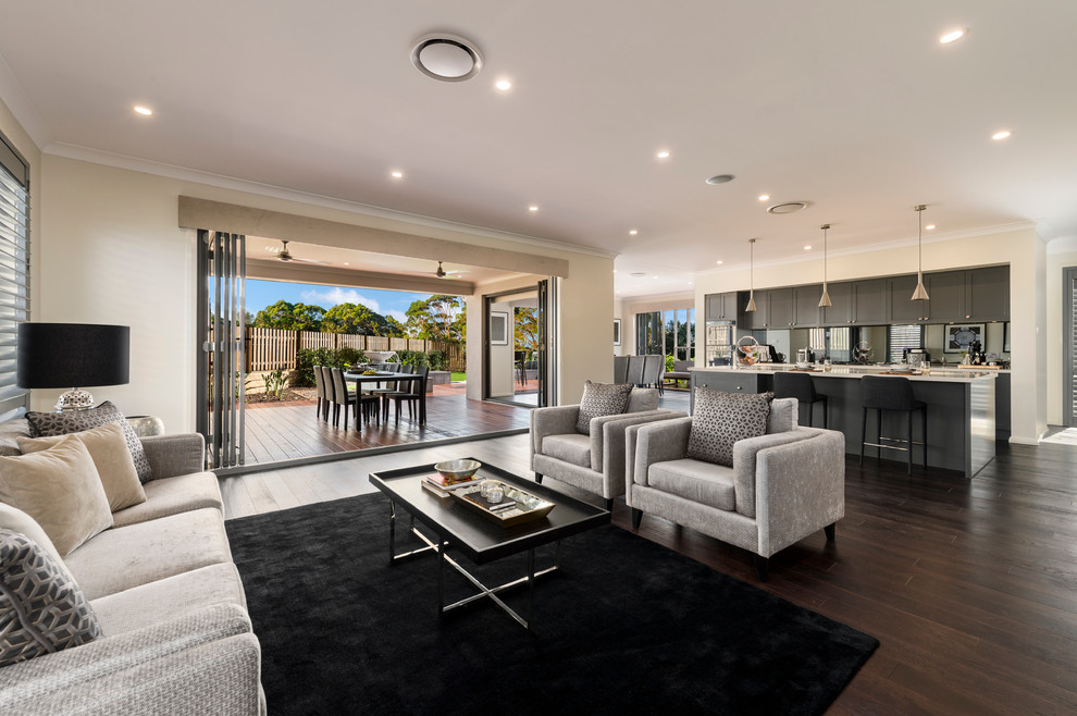Photo of a large contemporary open concept living room in Brisbane with beige walls and dark hardwood floors.