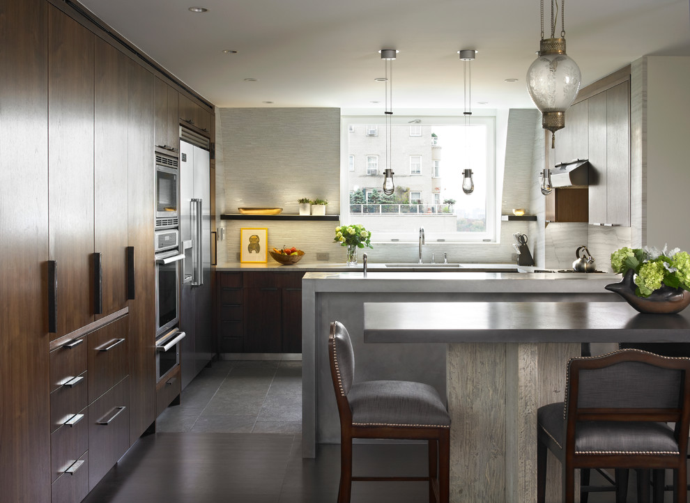 Photo of a contemporary u-shaped eat-in kitchen in New York with flat-panel cabinets and stainless steel appliances.