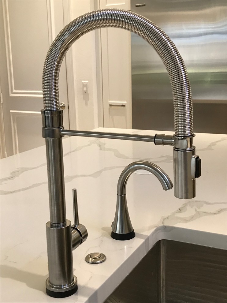 Large transitional kitchen photo in Miami with a farmhouse sink, shaker cabinets, white cabinets, quartz countertops, gray backsplash, glass tile backsplash, stainless steel appliances, an island and multicolored countertops