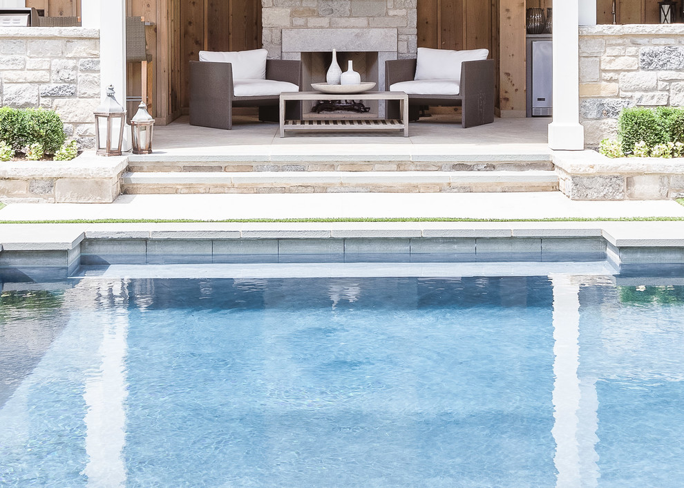 Inspiration for a large transitional backyard natural pool house remodel