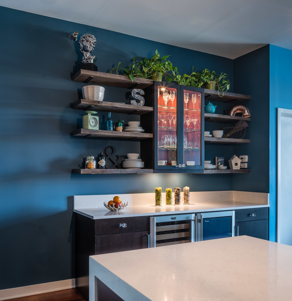 Photo of a small contemporary galley open plan kitchen in Chicago with a double-bowl sink, flat-panel cabinets, brown cabinets, quartz benchtops, blue splashback, glass tile splashback, stainless steel appliances, medium hardwood floors and a peninsula.