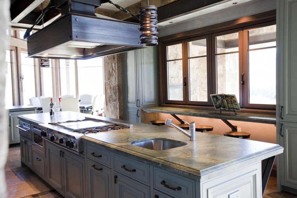 Large transitional kitchen photo in Denver with flat-panel cabinets, dark wood cabinets and an island