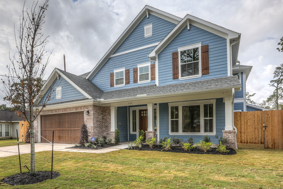 Large transitional blue two-story concrete fiberboard gable roof photo in Houston with a shingle roof