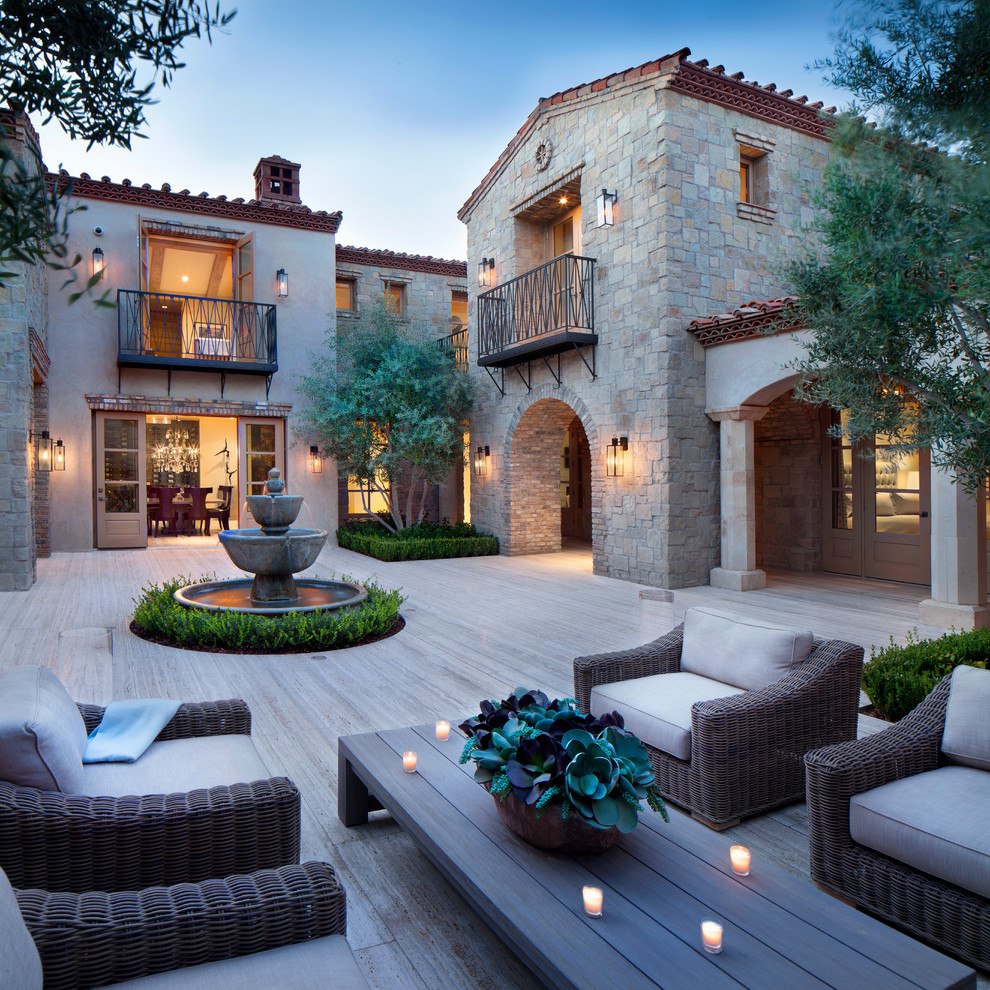 Inspiration for a mediterranean patio in Other with a water feature and no cover.