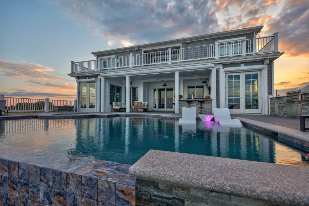 Hot tub - mid-sized contemporary backyard custom-shaped infinity hot tub idea with decking