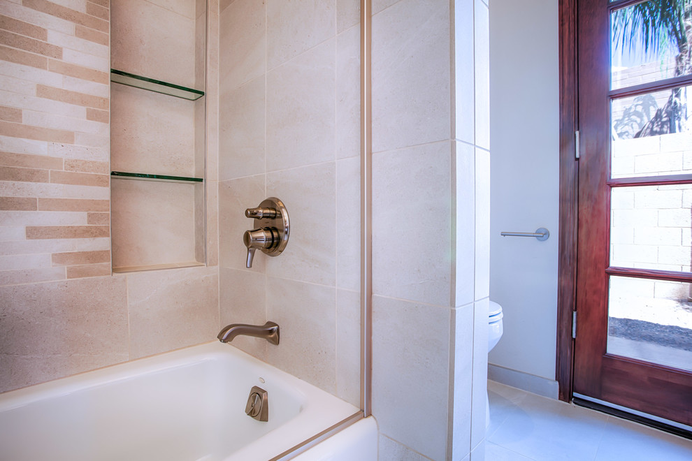 Small transitional beige tile and porcelain tile porcelain tile and beige floor alcove bathtub photo in Phoenix with flat-panel cabinets, medium tone wood cabinets, a one-piece toilet, beige walls, a vessel sink and granite countertops
