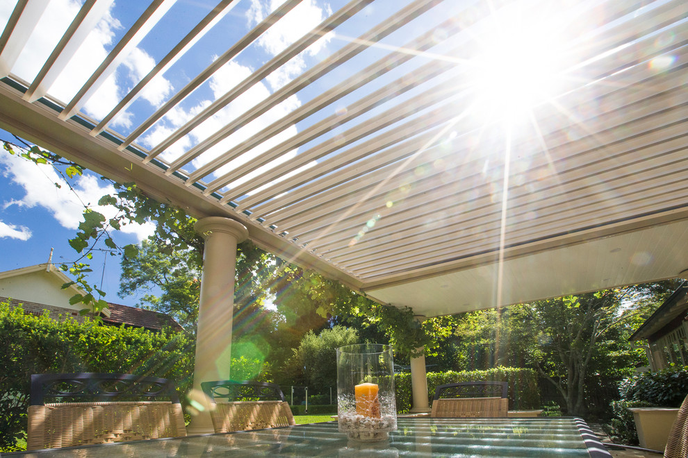 Design ideas for a large country backyard patio in Sydney with a pergola.