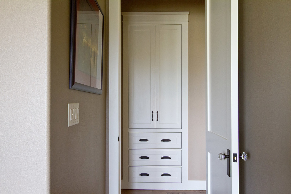 This is an example of a mid-sized arts and crafts hallway in Dallas with beige walls and medium hardwood floors.