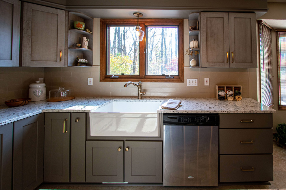 Mid-sized transitional kitchen in Cleveland with a farmhouse sink, flat-panel cabinets, grey cabinets, quartz benchtops, beige splashback, ceramic splashback, stainless steel appliances, ceramic floors, grey floor and multi-coloured benchtop.