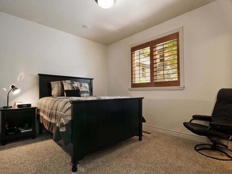 Mid-sized traditional gender-neutral kids' room in Salt Lake City with beige walls and carpet.