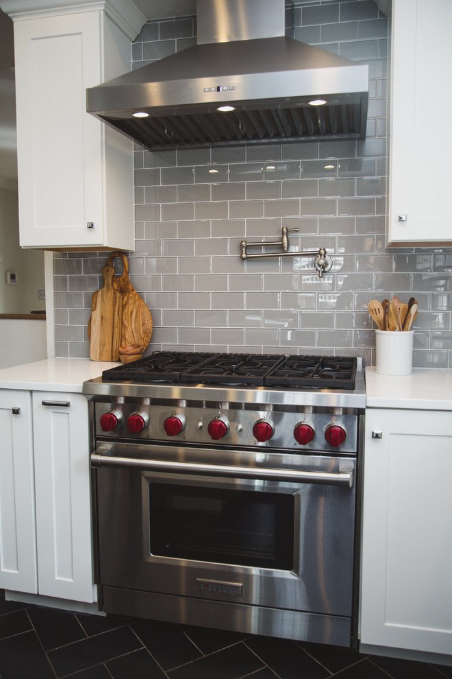 Inspiration for a mid-sized transitional u-shaped porcelain tile enclosed kitchen remodel in Denver with an undermount sink, shaker cabinets, white cabinets, quartz countertops, beige backsplash, subway tile backsplash, stainless steel appliances and an island