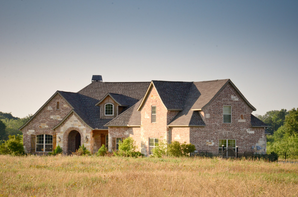 Photo of a traditional two-storey white house exterior in Dallas with mixed siding, a gable roof and a shingle roof.