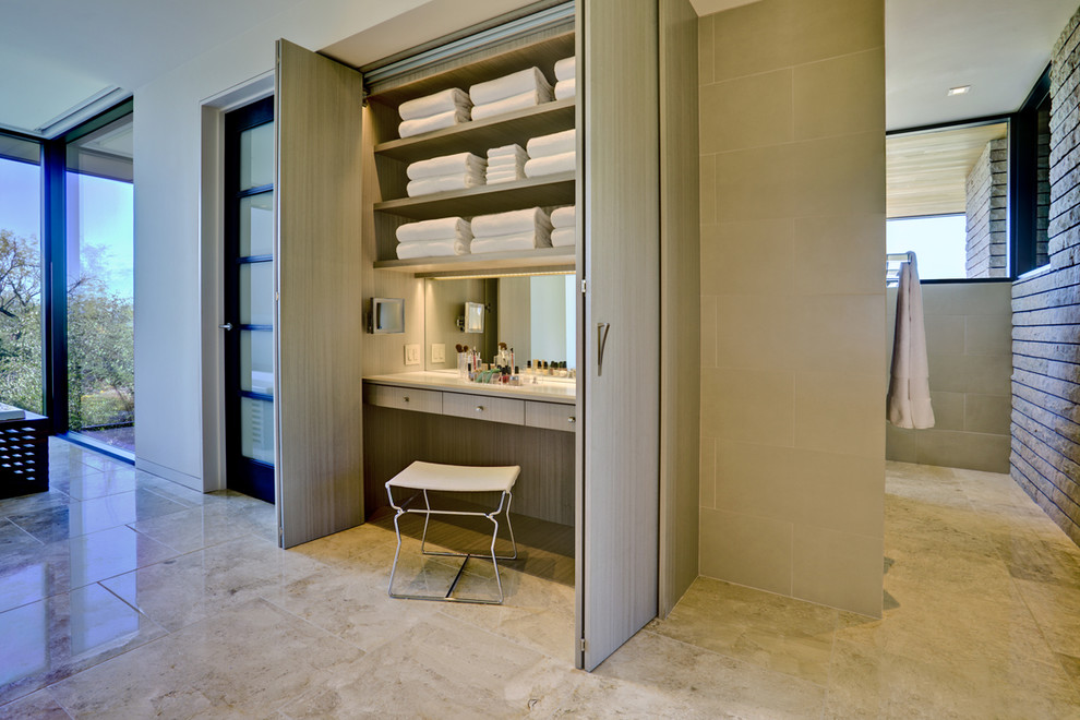 This is an example of a contemporary bathroom in Phoenix with open cabinets, light wood cabinets and beige tile.