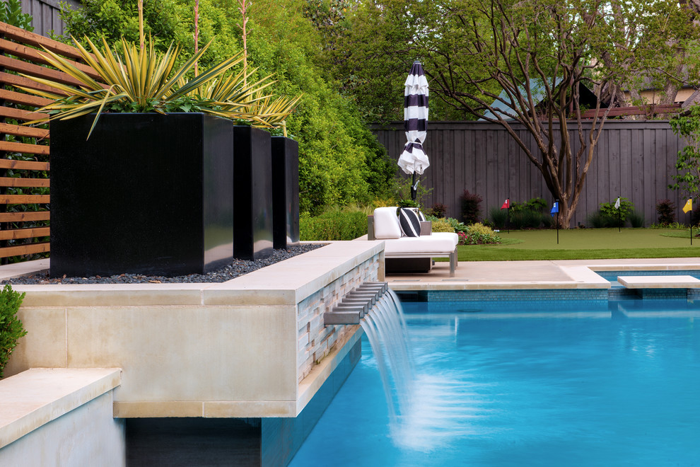 Inspiration for a mid-sized modern backyard rectangular pool in Dallas with a hot tub and concrete slab.
