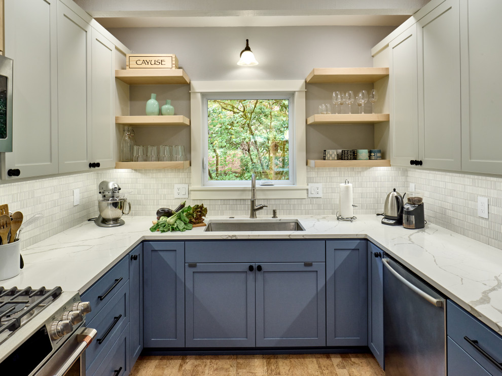 Photo of an eat-in kitchen in Other with a single-bowl sink, shaker cabinets, blue cabinets, quartz benchtops, grey splashback, ceramic splashback, stainless steel appliances, cork floors, with island, beige floor, white benchtop and exposed beam.